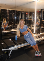 Jacklyn posing on a Pilates machine