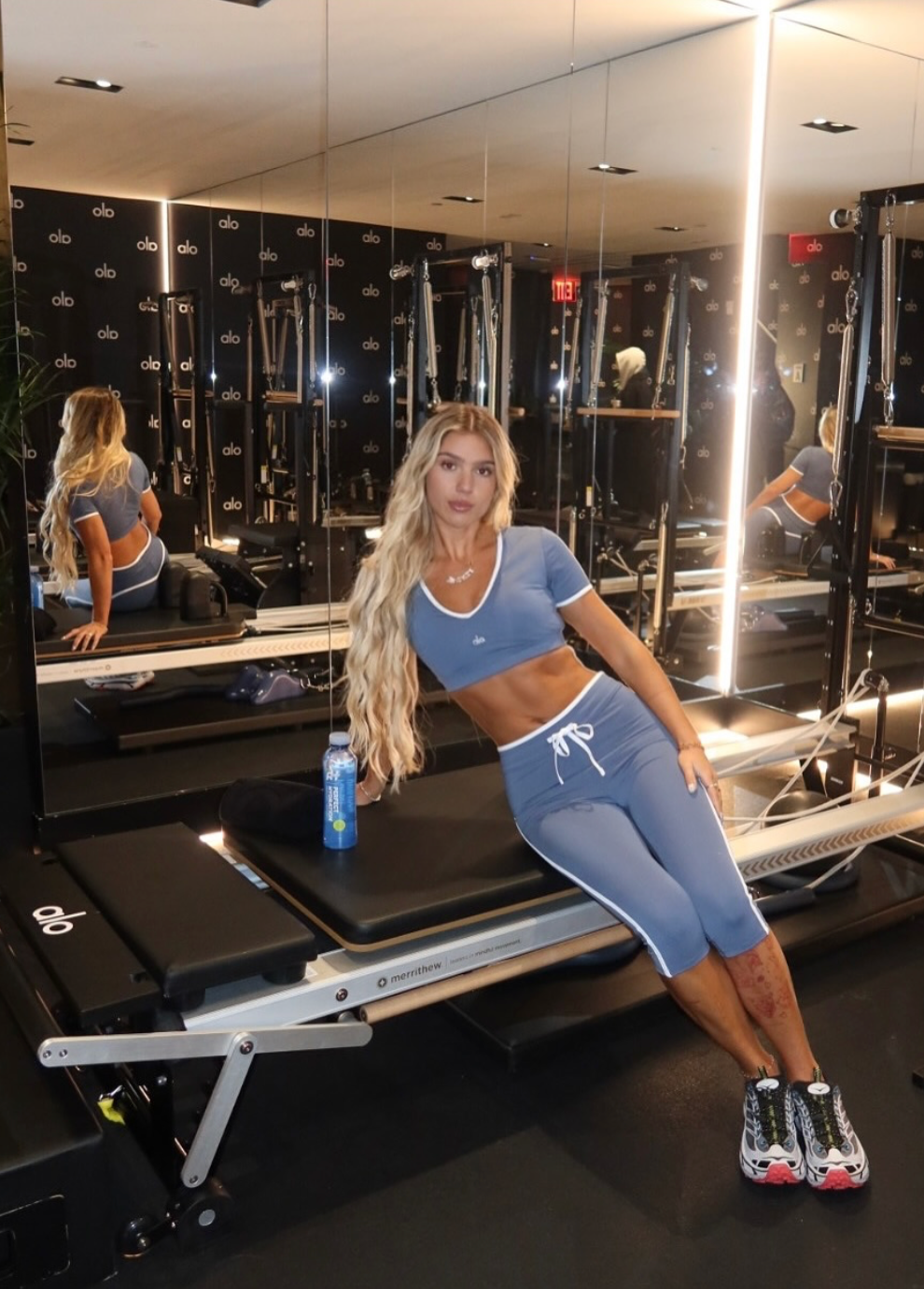 Jacklyn posing on a Pilates machine
